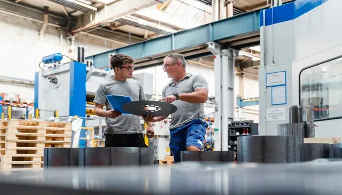 Two engineers discussing a quality gate inspection point in the manufacturing industry