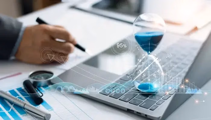 Hourglass on a laptop keyboard symbolizing time-to-market in business