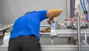 Technician working on machine improving first time fix rate in manufacturing