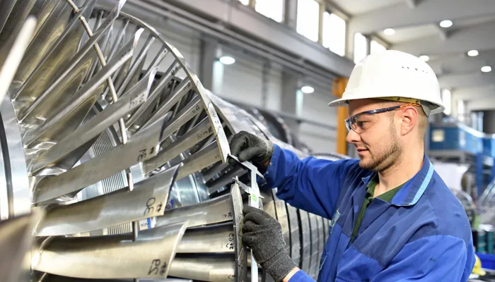 Technician inspecting turbine blade quality for MTTR reduction