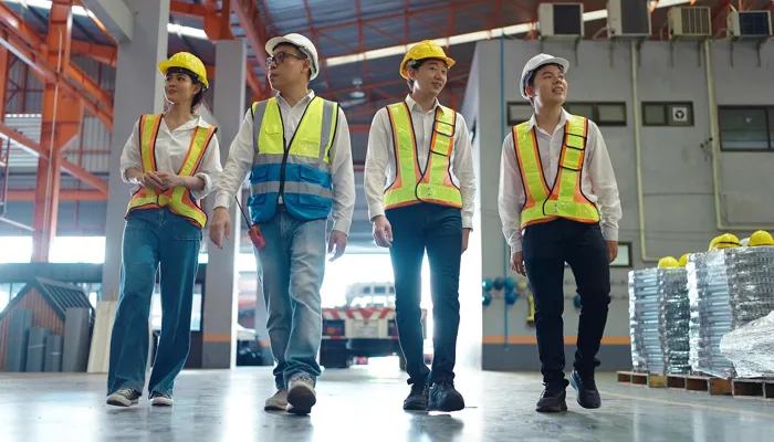 Team of engineers in a factory practicing Genchi Genbutsu