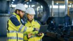 Workers using EHS Management Software to enhance safety and compliance in an industrial setting